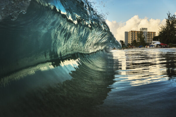 A large shore breaking wave at Pebbles Beach Barbados by Fine Art Photographer Andre Donawa