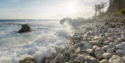 Fine art photograph of splashing waves and pebbles, Bathsheba, Barbados by Andre Donawa.