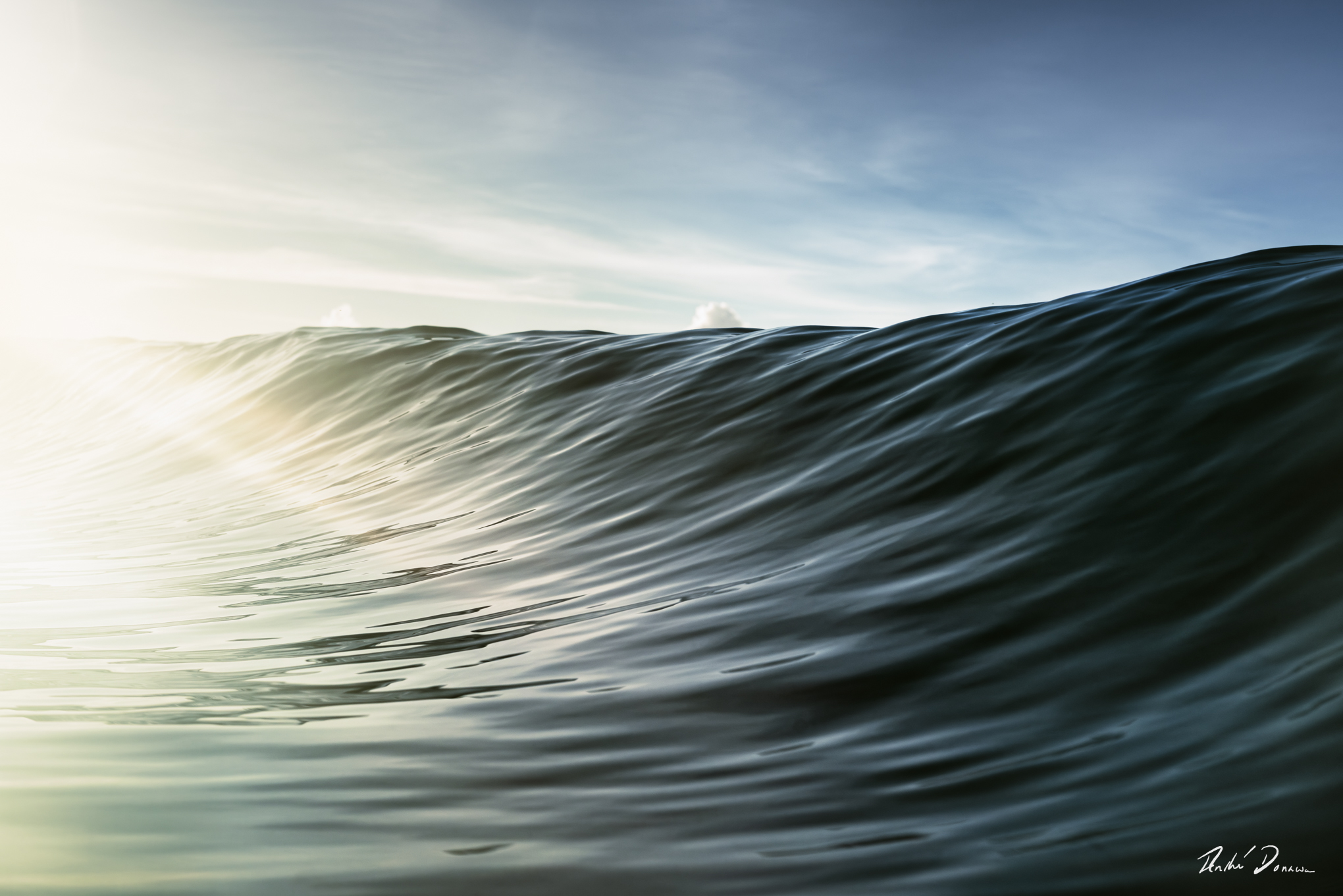 Light reflections on a wave early in the morning