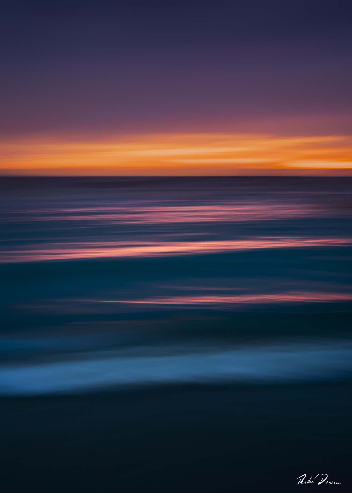 Abstract seascape created with Intentional Camera Movement photography during golden hour, featuring horizontal wave lines and a blurred ocean horizon