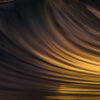 Abstract seascape created with Intentional Camera Movement photography during golden hour, featuring horizontal wave lines and a blurred ocean horizon