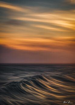 Abstract seascape created with Intentional Camera Movement photography during golden hour, featuring horizontal wave lines and a blurred ocean horizon