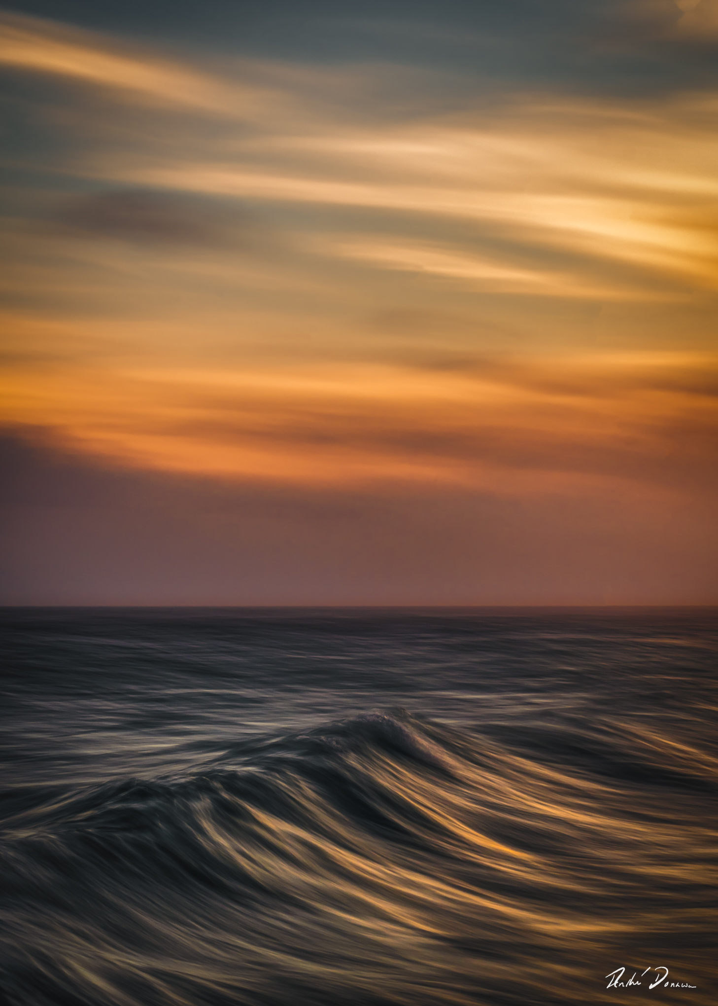 Abstract seascape created with Intentional Camera Movement photography during golden hour, featuring horizontal wave lines and a blurred ocean horizon