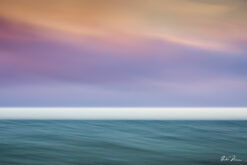 Abstract seascape created with Intentional Camera Movement photography during golden hour, featuring horizontal wave lines and a blurred ocean horizon